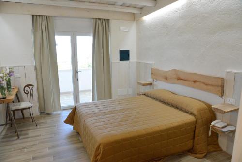 莫诺波利马赛利亚圣塔特雷莎酒店的一间卧室设有一张床和一个大窗户