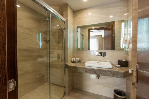 第比利斯KMM酒店的一间带水槽和玻璃淋浴的浴室