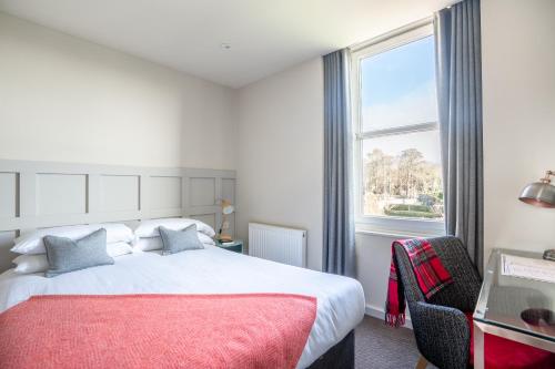 皮布尔斯帕克旅馆的一间卧室设有一张大床和一个窗户。