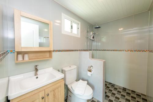 浦阿Baan Kang Hun Pua Cottage的浴室配有卫生间、盥洗盆和淋浴。
