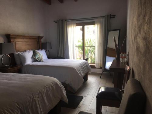 Hotel Concierge Flor y Canto客房内的一张或多张床位