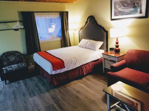 普林斯顿Ace Motel的配有一张床和一把椅子的酒店客房