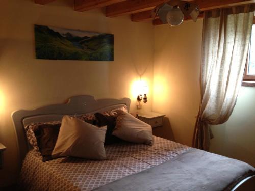 菲乌马尔博阿尔卑斯萨拉农家乐的一间卧室配有带枕头的床