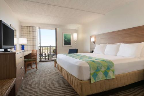 科珀斯克里斯蒂DoubleTree by Hilton Corpus Christi Beachfront的酒店客房设有一张大床和一台电视。