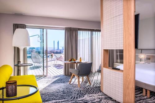 波尔多Radisson Blu Hotel Bordeaux的酒店客房设有一张特大号床和一个阳台。