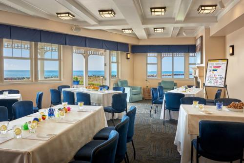 半月湾半月湾海滩酒店的一个带桌椅的会议室和海洋
