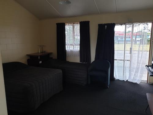 Foxtoncastletown motel的客房设有床、沙发和窗户。