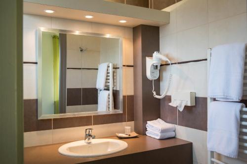 Saint-Martin-dʼUriage梅桑酒店的一间带水槽和镜子的浴室