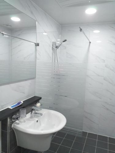 大邱Seong Dong Jang的白色的浴室设有水槽和淋浴。
