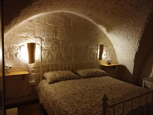 奥斯图尼Ivory的卧室配有一张石墙床