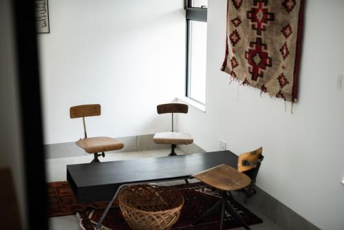 金泽Kamin Kanazawa的地毯间配有两把椅子和一张桌子