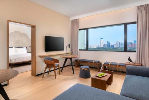 北京北京首北兆龙饭店的酒店客房设有沙发、电视和床。