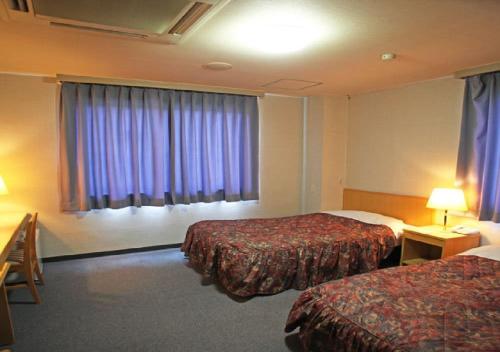 阿南Bayside Hotel Ryugu / Vacation STAY 63714的酒店客房设有两张床和窗户。