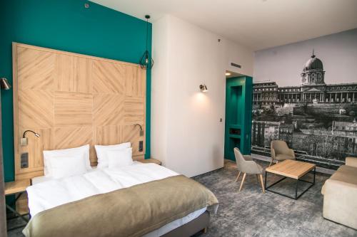 布达佩斯T62 Hotel的酒店客房设有一张大床和一张书桌。