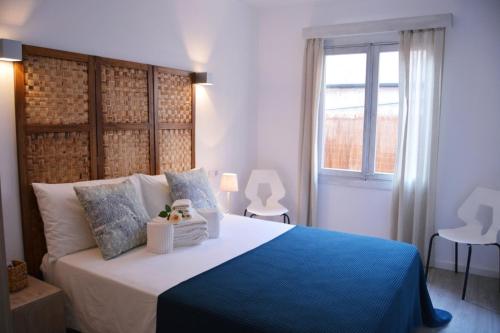 坎皮卡福特Sea House Can Picafort的一间卧室配有一张带蓝色毯子的大床