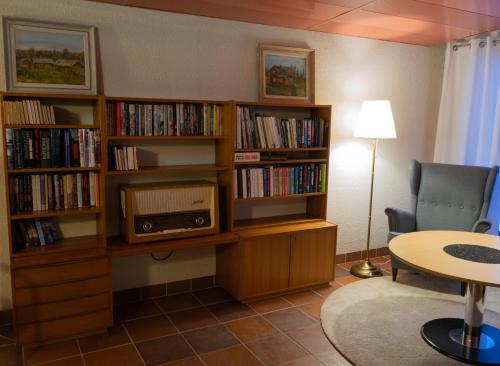 斯图吕曼Hotell Toppen的客厅配有书架,书架上装满了书籍