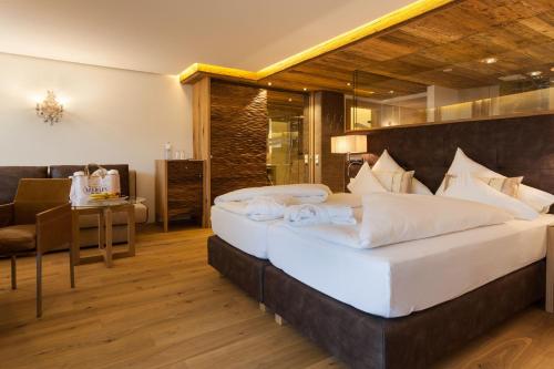 萨尔巴赫诺伊豪斯酒店的一间卧室配有两张床、一张桌子和一把椅子