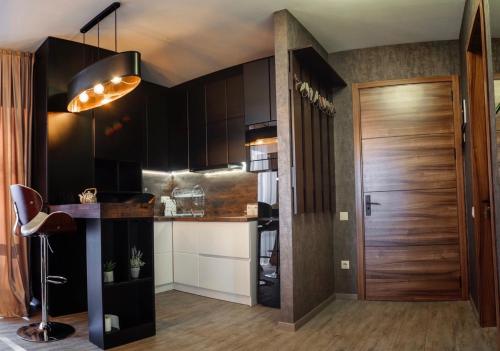 巴库里阿尼Bakuriani area park 57的厨房配有黑色橱柜和木门。