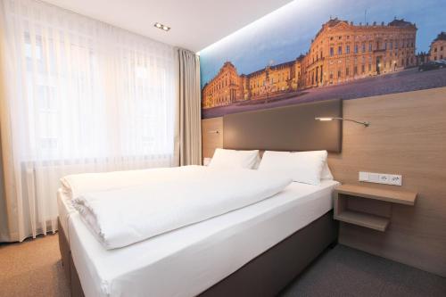 维尔茨堡维尔茨堡城市酒店旅馆的一间卧室配有一张壁画床