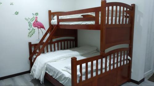宾南邦爱上海蓝蓝屋民宿 Blue Ocean Station的一间有粉色鸟的房间,配有两张双层床