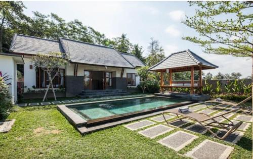 BringkitTiTi Villa的一座带游泳池和凉亭的房子