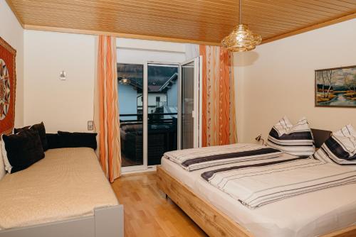 斯皮特安德劳Ferienwohnung Hartlieb Goldeck Millstättersee的一间卧室设有两张床和大窗户
