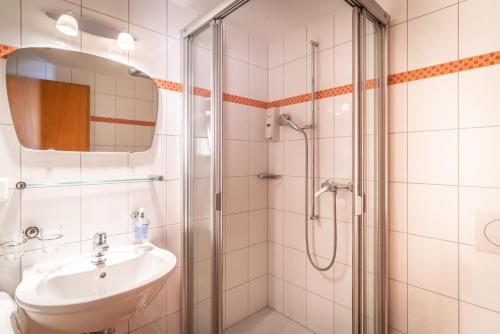 奥塞尔贝格VISP erblick H O T E L AUSSERBERG & Late Check-in的一间带水槽和淋浴的浴室