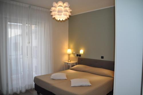 格拉多蕾佳娜酒店的一间卧室配有一张带两个白色枕头的床