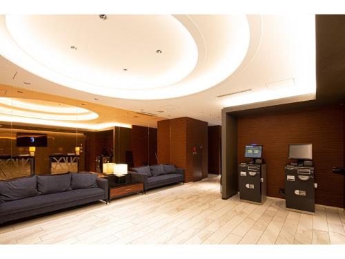 熊本Place Hotel Ascot的带沙发和大型天花板的客厅