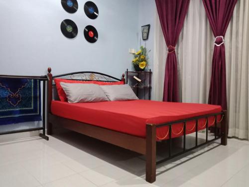 加央玻璃塞里尼帕度假屋的一间卧室配有一张带红色毯子的床