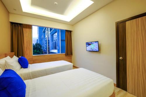 Desatu Hotel客房内的一张或多张床位