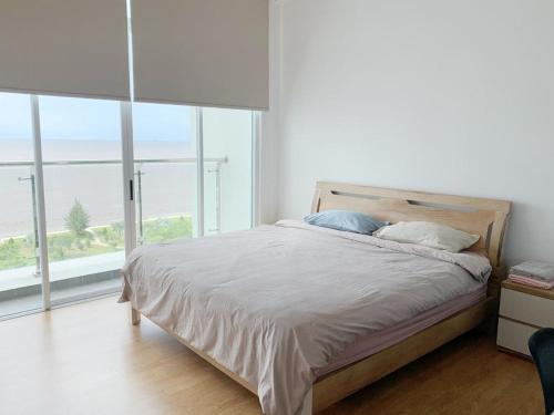 米里Bay Resort Condominium, 7, Beach-front Sea view, 6-8 PAX的一间卧室设有一张床,享有海景