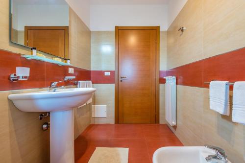 莱切GoodStay Archimede Apartment的一间带水槽、卫生间和镜子的浴室