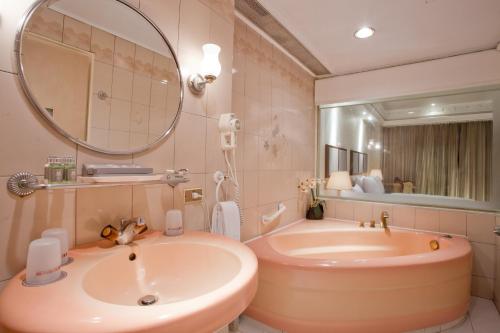 台北乔合大饭店的带浴缸、水槽和镜子的浴室