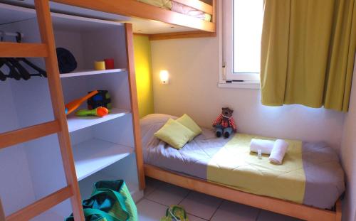 蒙塔尼亚克VVF Montagnac Hérault的一间小儿童卧室,配有一张双层床和梯子