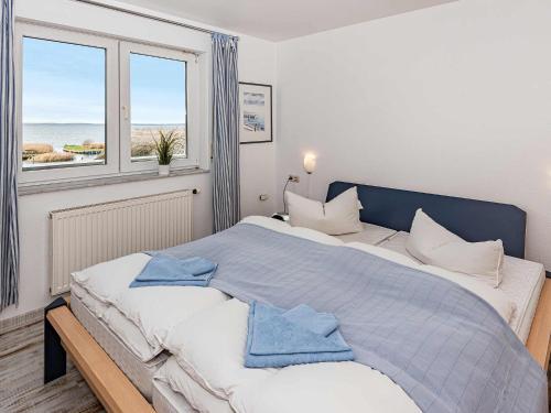 洛丁Aquarius Ferienwohnung Usedom的一间卧室配有一张大床和两条毛巾