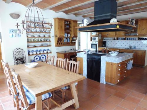 圣米克尔德巴兰Belvilla by OYO Casa Lourdes的厨房配有木桌和炉灶。