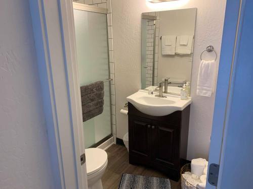 科达伦North Idaho Inn的一间带水槽、卫生间和镜子的浴室