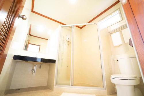 亚兰Baan Anong Hotel的一间带卫生间和玻璃淋浴间的浴室