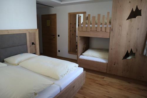 安纳贝格-伦格茨阿尔彭霍夫安娜贝格酒店的带两张双层床的客房中的两张床