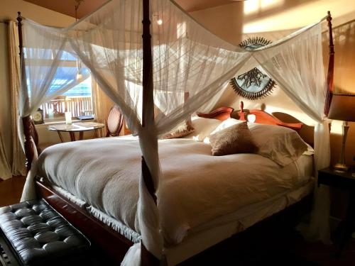 锡谢尔特杜瓦克Spa酒店的一间卧室配有带蚊帐的天蓬床。
