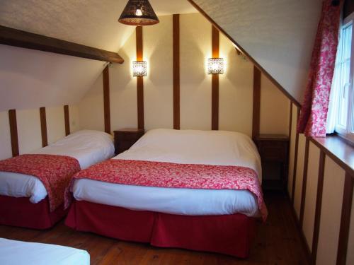 阿内勒Maisonnette LE COTTAGE à 50m du FRONT DE MER à Asnelles , 3km d'Arromanches, 10km de Bayeux的一间卧室,配有两张床