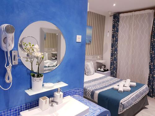 马德里马德里大街旅馆的浴室设有两张床、镜子和水槽