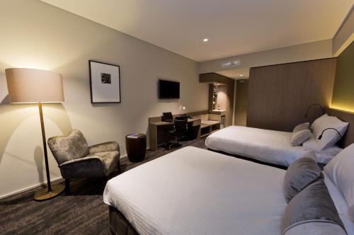 布里斯班格伦套房酒店的酒店客房配有两张床和一张书桌