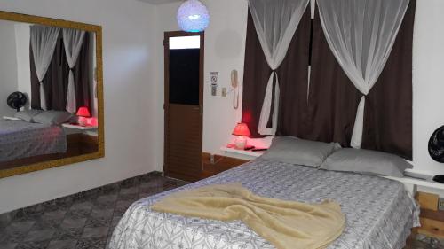 兰巴里Pousada São Pedro的一间卧室配有一张床铺,床上有毯子