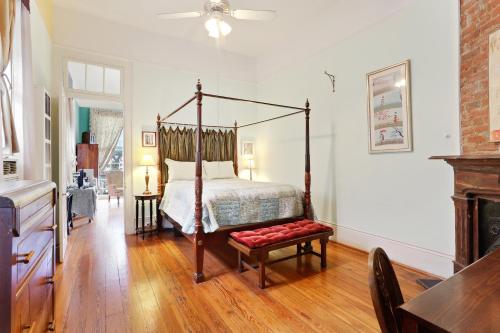 新奥尔良Garden District Bed and Breakfast的一间卧室配有四柱床和椅子