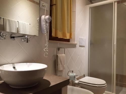 费拉约港Hotel Il Caminetto的一间带水槽、卫生间和淋浴的浴室