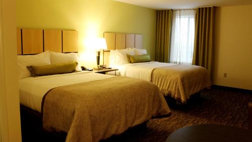 苏城苏城南山烛木套房酒店的酒店客房设有两张床和窗户。