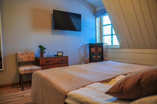Kokemäki玛雅提拉马特卡路阿里克拖拉酒店的卧室配有一张床,墙上配有电视。