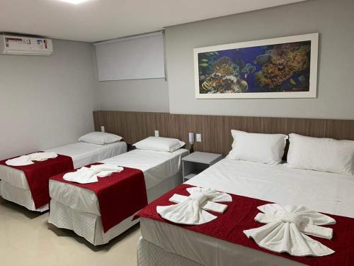 马塞约Summit Pousada Noah的一间设有两张红色和白色毯子的房间
